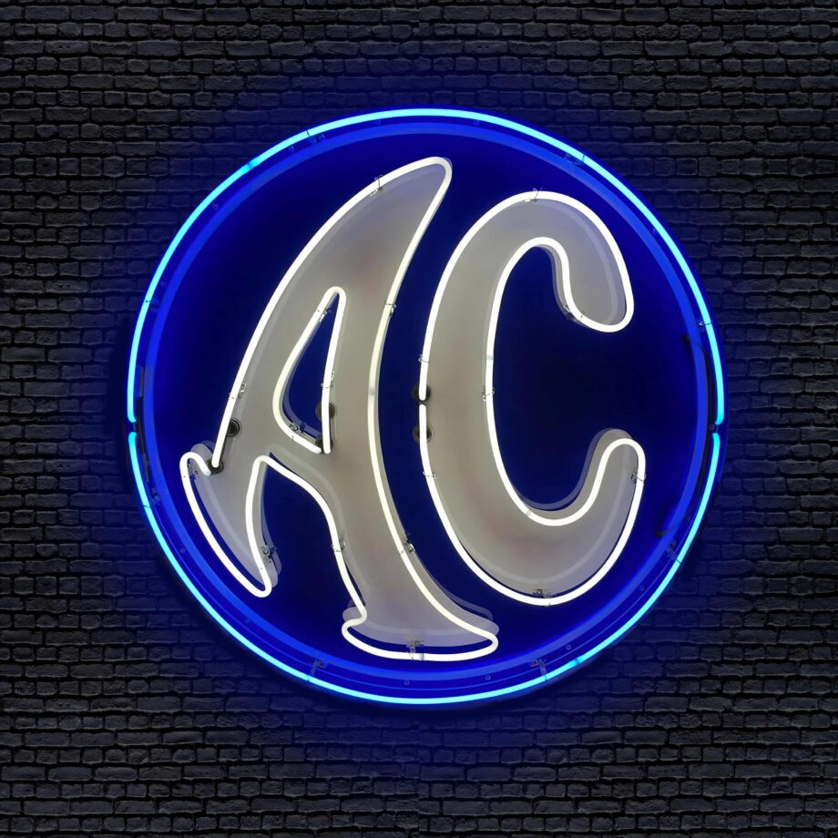 AC Cars 46" Round Neon Sign over Brick background at Garage Art