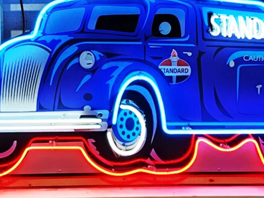 The Standard Fuel Company's tanker truck in a neon sign